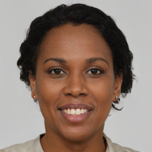 Joyful black young-adult female with short  brown hair and brown eyes
