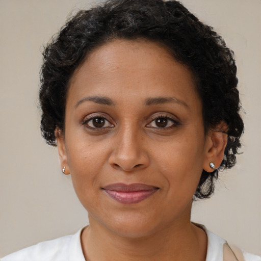 Joyful black adult female with short  brown hair and brown eyes