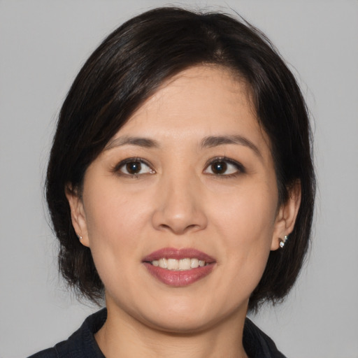 Joyful asian young-adult female with medium  brown hair and brown eyes