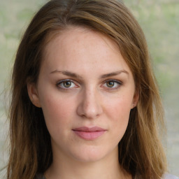 Joyful white young-adult female with long  brown hair and green eyes