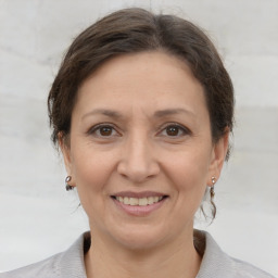 Joyful white adult female with medium  brown hair and brown eyes