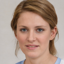 Joyful white young-adult female with medium  brown hair and blue eyes