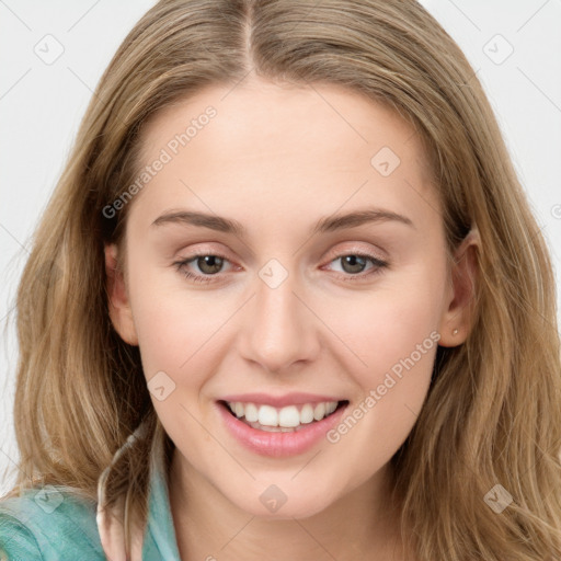 Joyful white young-adult female with long  brown hair and blue eyes