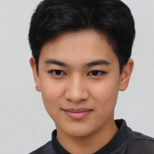 Joyful asian young-adult male with short  brown hair and brown eyes