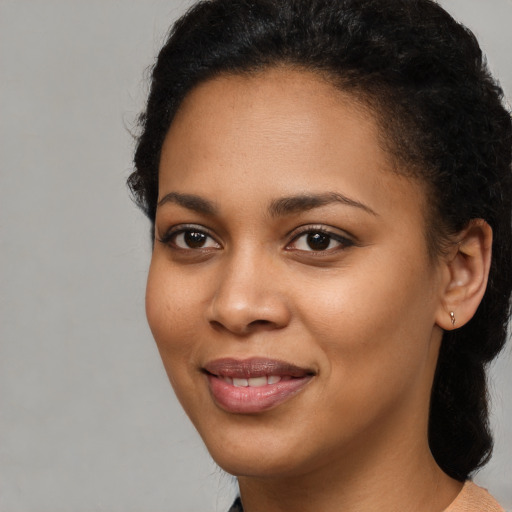 Joyful latino young-adult female with short  black hair and brown eyes
