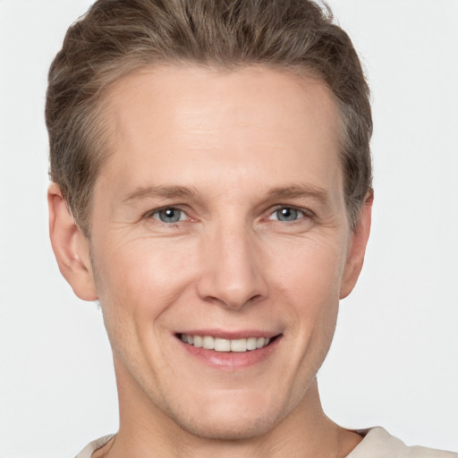 Joyful white adult male with short  brown hair and grey eyes