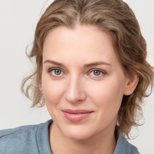 Joyful white young-adult female with medium  brown hair and blue eyes