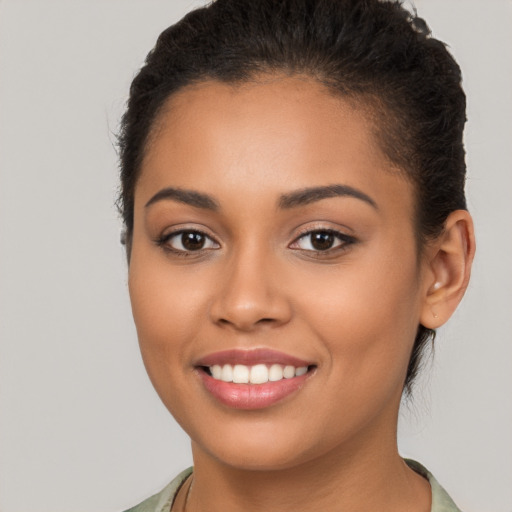 Joyful latino young-adult female with long  brown hair and brown eyes