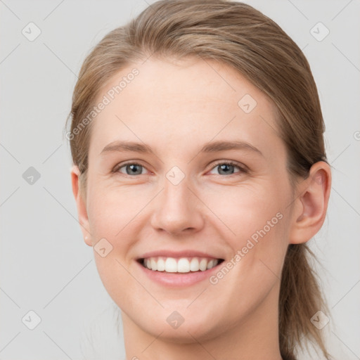 Joyful white young-adult female with medium  brown hair and blue eyes