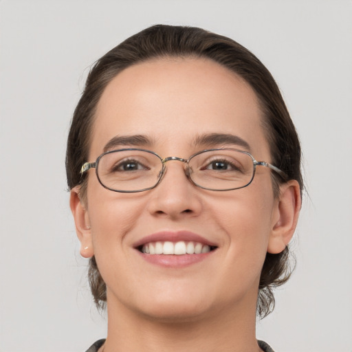 Joyful white young-adult female with medium  brown hair and grey eyes