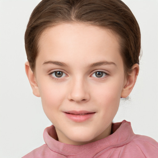 Joyful white child female with short  brown hair and grey eyes