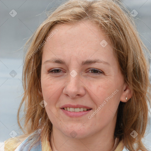 Joyful white adult female with medium  brown hair and grey eyes