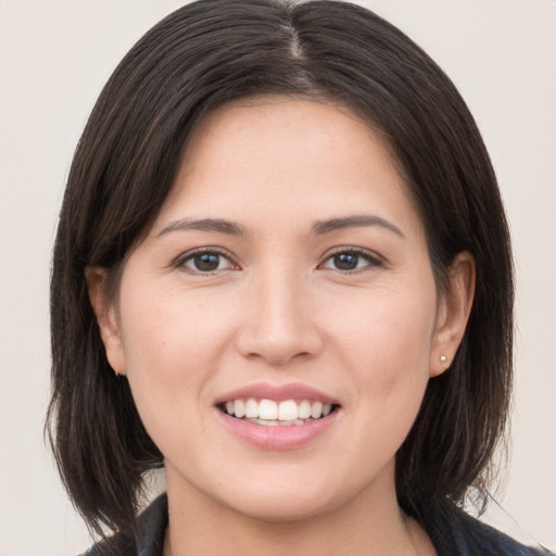 Joyful white young-adult female with medium  brown hair and brown eyes