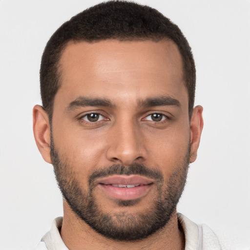 Joyful black young-adult male with short  brown hair and brown eyes