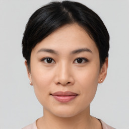 Joyful asian young-adult female with short  black hair and brown eyes