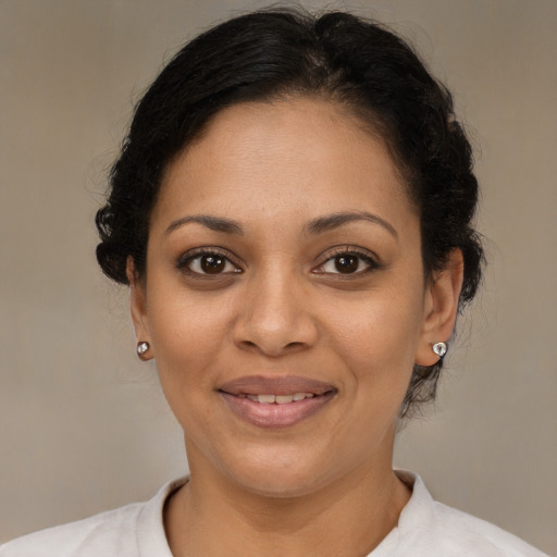 Joyful latino adult female with short  brown hair and brown eyes
