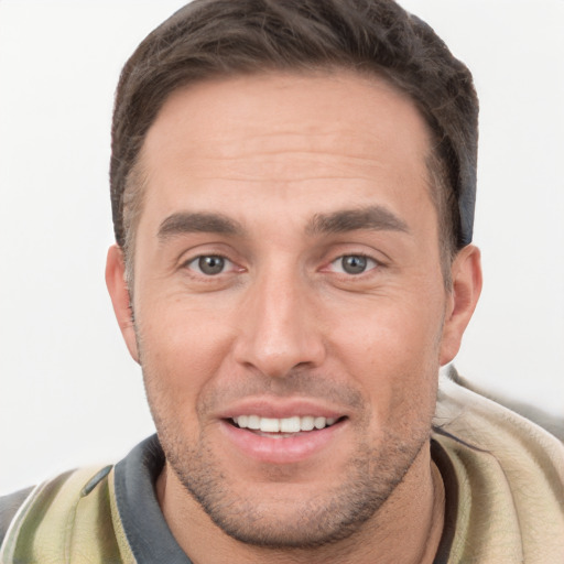 Joyful white young-adult male with short  brown hair and brown eyes