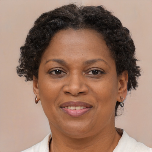 Joyful black adult female with short  brown hair and brown eyes