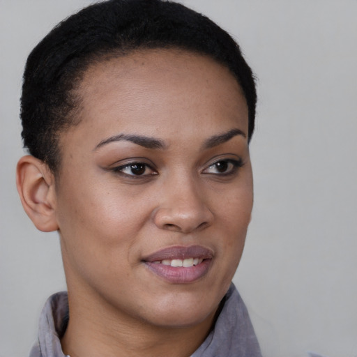 Joyful black young-adult female with short  brown hair and brown eyes