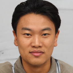 Joyful asian young-adult male with short  black hair and brown eyes