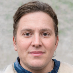 Joyful white adult male with short  brown hair and grey eyes