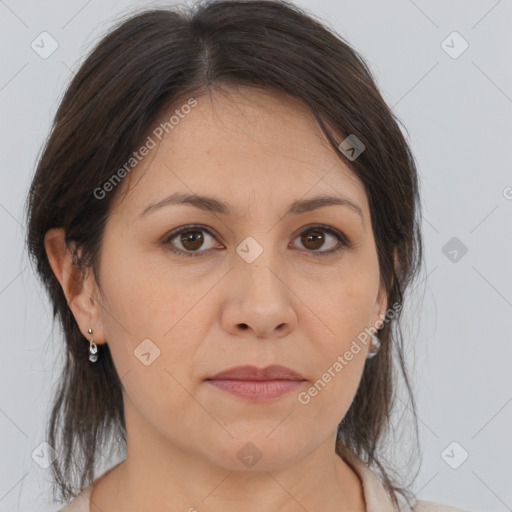 Joyful white adult female with medium  brown hair and brown eyes