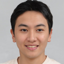 Joyful asian young-adult male with short  black hair and brown eyes