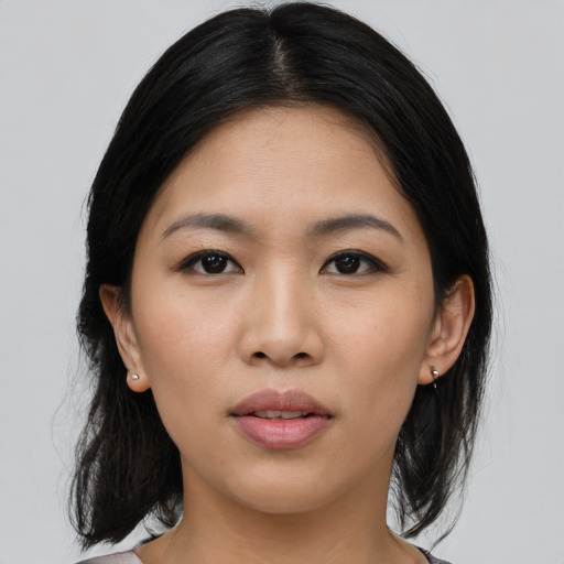 Joyful asian young-adult female with medium  black hair and brown eyes