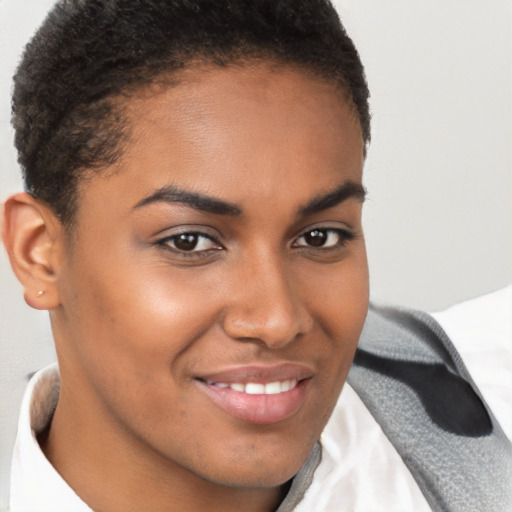 Joyful black young-adult female with short  brown hair and brown eyes