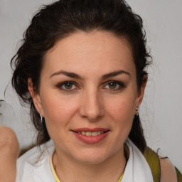 Joyful white adult female with medium  brown hair and brown eyes