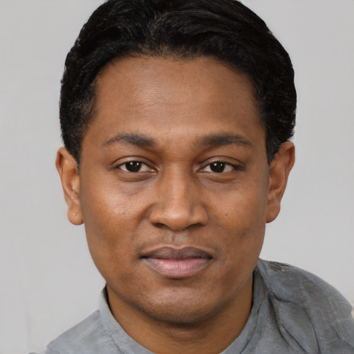 Joyful latino adult male with short  black hair and brown eyes