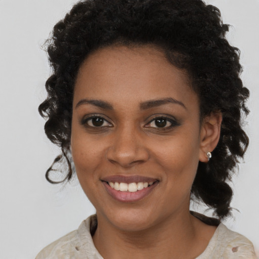 Joyful black young-adult female with medium  brown hair and brown eyes