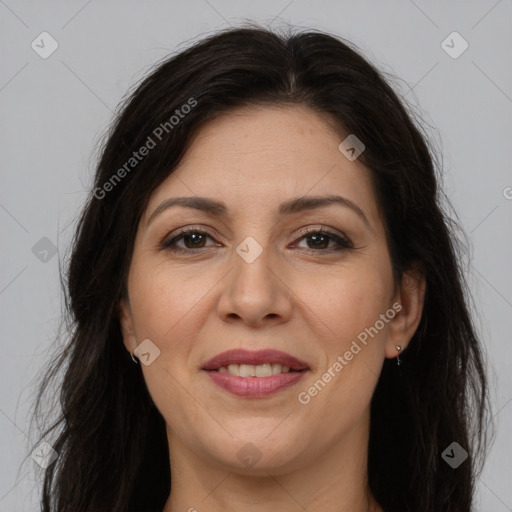 Joyful white adult female with long  brown hair and brown eyes