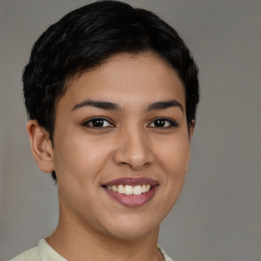 Joyful latino young-adult female with short  brown hair and brown eyes