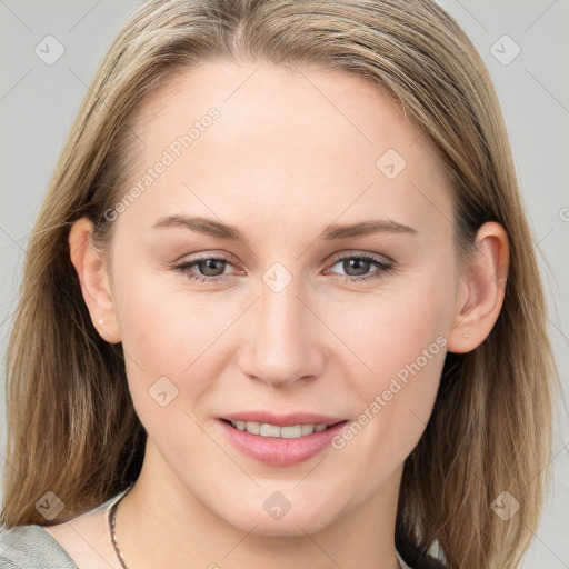 Joyful white young-adult female with long  brown hair and blue eyes