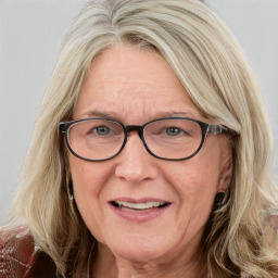 Joyful white middle-aged female with medium  brown hair and blue eyes