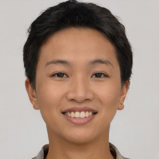 Joyful asian young-adult female with short  brown hair and brown eyes