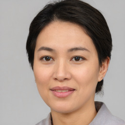 Joyful asian young-adult female with medium  brown hair and brown eyes