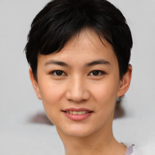 Joyful asian young-adult female with short  black hair and brown eyes