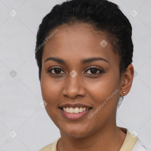 Joyful black young-adult female with short  brown hair and brown eyes