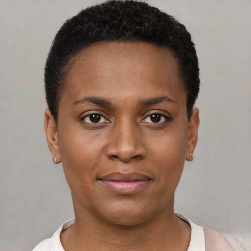 Joyful black young-adult female with short  brown hair and brown eyes