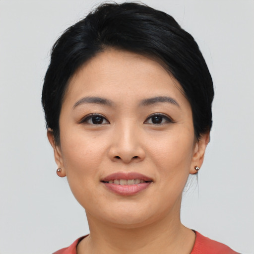 Joyful asian young-adult female with short  black hair and brown eyes