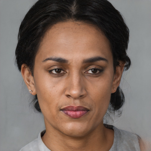 Joyful latino young-adult female with medium  black hair and brown eyes