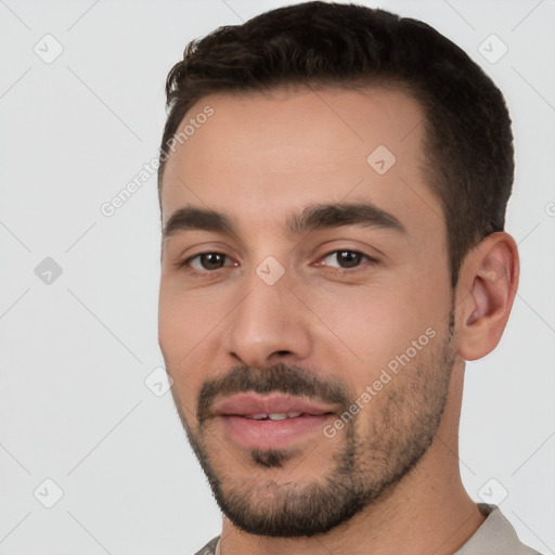 Joyful white young-adult male with short  black hair and brown eyes