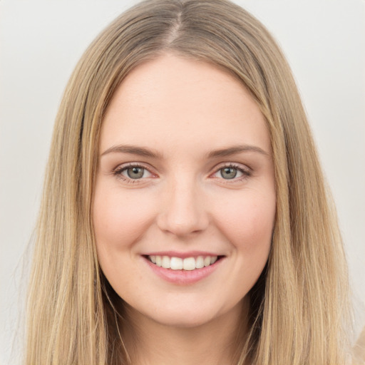 Joyful white young-adult female with long  brown hair and green eyes