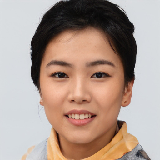 Joyful asian young-adult female with short  black hair and brown eyes