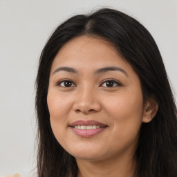 Joyful asian young-adult female with long  brown hair and brown eyes