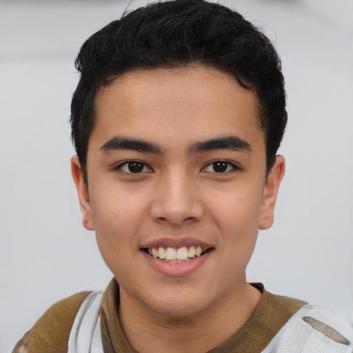 Joyful asian young-adult male with short  black hair and brown eyes