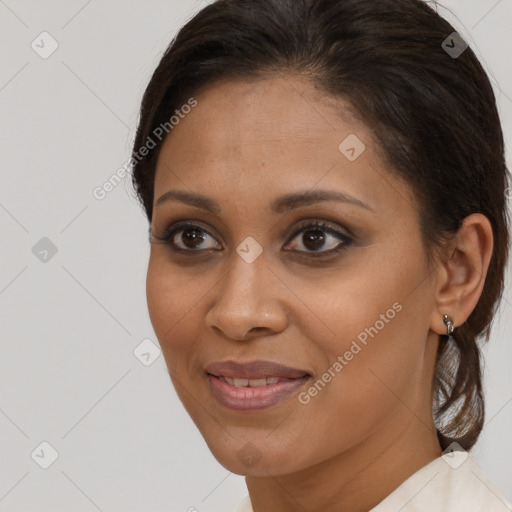 Joyful black young-adult female with long  brown hair and brown eyes