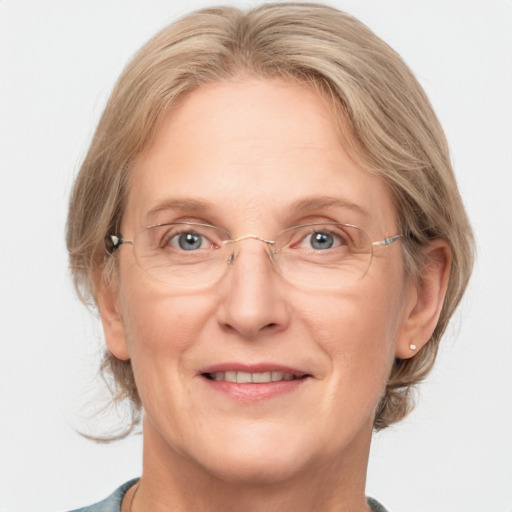 Joyful white adult female with medium  brown hair and blue eyes